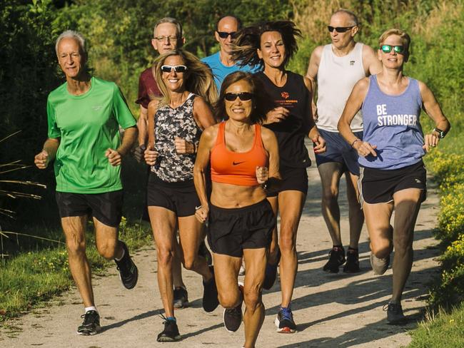 Jeannie Rice, centre, runs with a running group. Published Credit: Andrew Spear for The Wall Street Journal