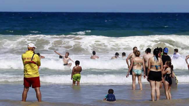 Volunteer Surf Life Savers looking over swimmers enjoying the sun and ocean at Surfers Paradise Beach on a hot Boxing Day. Picture: Jerad Williams