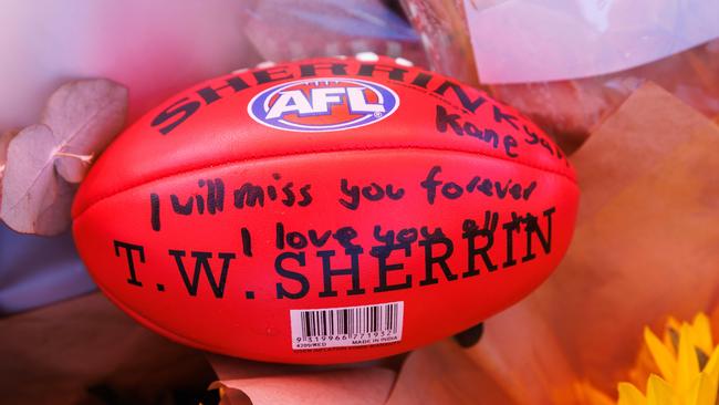 A footy with messages of love and loss. Picture: David Swift