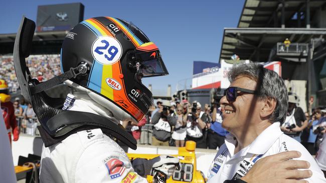 Fernando Alonso, left, of Spain, is congratulated by a crew member during qualifications.