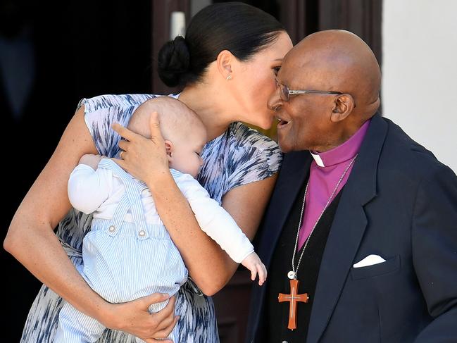 The Duchess of Sussex speaks to Archbishop Desmond Tutu while holding her baby son Archie Mountbatten-Windsor. Picture: Toby Melville/Getty Images