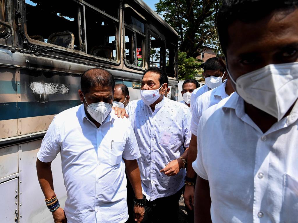 Mahinda Rajapaksa, centre, is escorted near Gotabaya Rajapaksa’s home. Picture: Ishara S. Kodikara/AFP