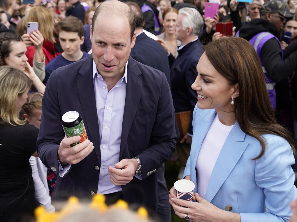 Prince William is gifted a special “Coronation Ale” as a thrilled Princess Catherine looks on. Picture: Getty Images