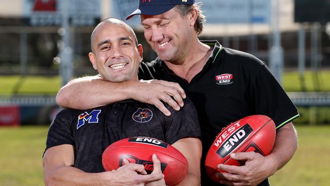 Andrew McLeod with rival captain Tony Modra ahead of this year’s charity Slowdown match. His charges will be a tad younger at St Michael’s College. Picture: Calum Robertson