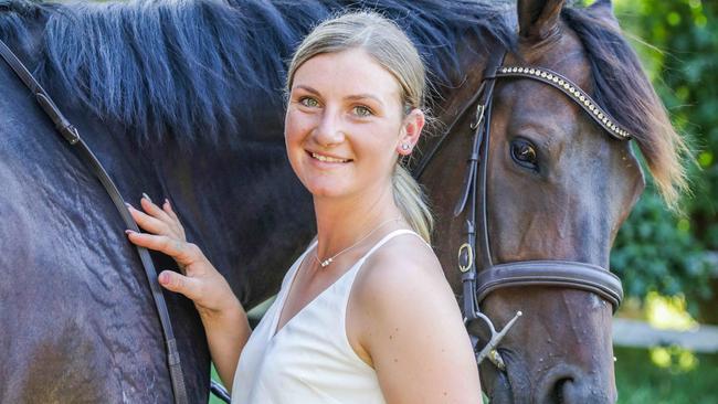 Jamie Kah, 23, is one of Australia's leading jockeys. Here with Brax, former race horse which she is retraining into a show jumping horse. Picture- Nicole Cleary