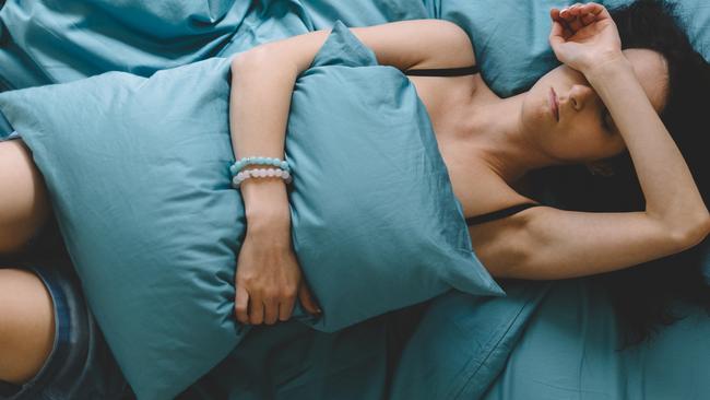 Depressed woman in bed with hand on forehead  Picture: istock