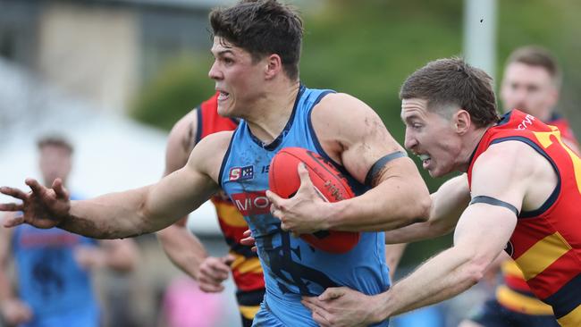 Star Double Blues midfielder Tom Lewis bursts clear under pressure from Adelaide’s Louis Sharrad at Unley Oval on Saturday. Picture: David Mariuz/SANFL