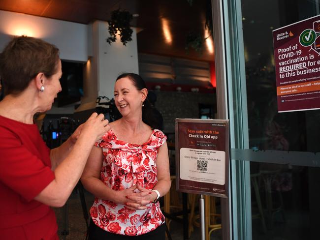 Queensland Health Minister Yvette D'Ath and Small Business Minister Di Farmer look at a sign informing patrons they must be vaccinated to enter the premises at the Story Bridge Hotel in Brisbane. Picture: NCA NewsWire / Dan Peled