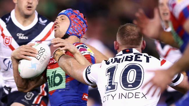 Kalyn Ponga of the Knights is tackled by Matthew Lodge (Photo by Matt King/Getty Images)