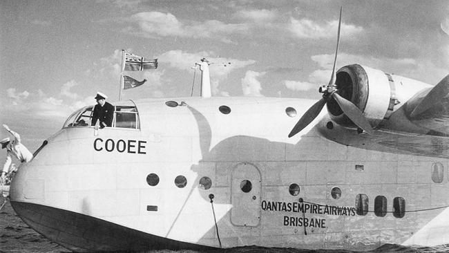 Qantas's Cooee captain Bill Crowther looks on as radio officer Glen Mumford casts off from a mooring.