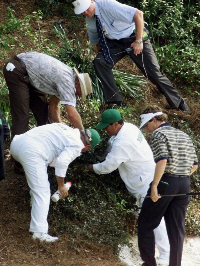 Greg Norman looks for his ball behind the 12th hole in 1999.