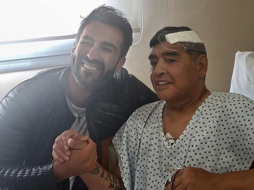 Argentine football legend Diego Maradona shaking hands with his doctor Leopoldo Luque earlier this month. Photo: Diego Maradona press office and AFP.