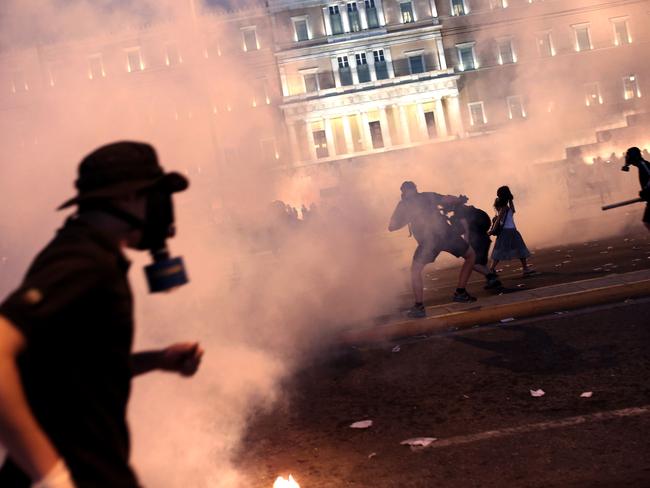 A protester clashes with riot police.