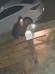 Police are investigating an explosion after the masked man was caught placing a glowing device in a letterbox on CCTV. Picture: Supplied