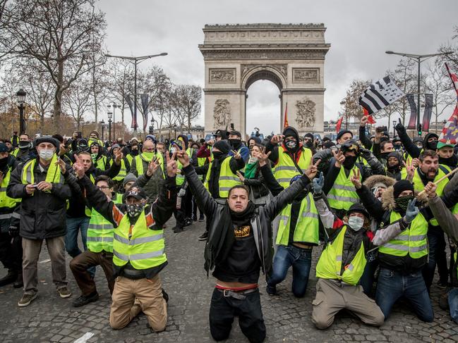 PARIS, FRANCE - DECEMBER 08: Protesters chant slogans during the 'yellow vests' demonstration on the Champs-ElysÃ©es near the Arc de Triomphe on December 8, 2018 in Paris France. ''Yellow Vests' ('Gilet Jaunes' or 'Vestes Jaunes') is a protest movement without political affiliation which was inspired by opposition to a new fuel tax. After a month of protests, which have wrecked parts of Paris and other French cities, there are fears the movement has been infiltrated by 'ultra-violent' protesters. Today's protest has involved at least 5,000 demonstrators gathering in the Parisian city centre with police having made over 200 arrests so far.  (Photo by Chris McGrath/Getty Images)