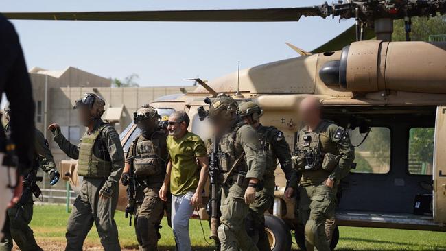 Freed Israeli hostage Kaid Alkadi accompanied by soldiers as he disembarks from a military helicopter at the Soroka Medical Center in Beersheba. Picture; AFP.