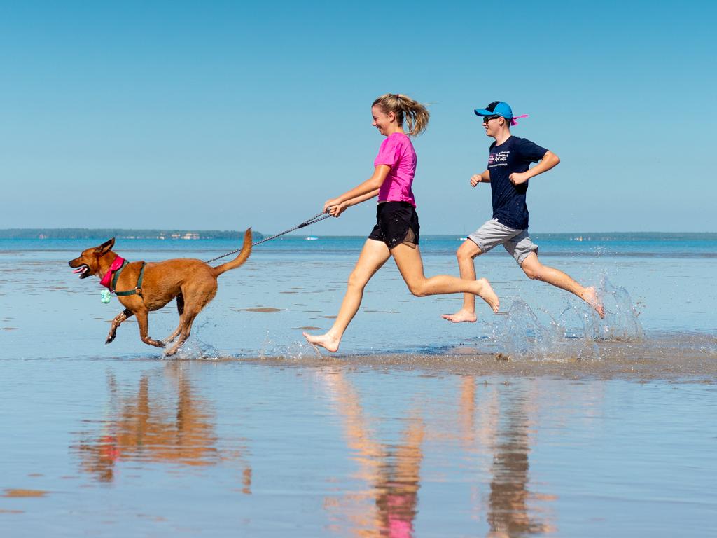 The annual Mother's Day Classic supporting breast cancer research was held along the East Point foreshore in 2021. Jade and Beau Stroud with Skye the dog run on East Point beach. Picture: Che Chorley