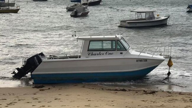 A half-cabin cruiser torn from its mooring by high winds and blown on to Forty Baskets Beach at Balgowlah Heights on Monday morning. Picture: Facebook