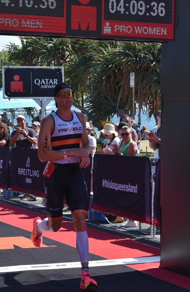 Athletes crossing the finish line at Sunshine Coast Ironman 70.3 2023.