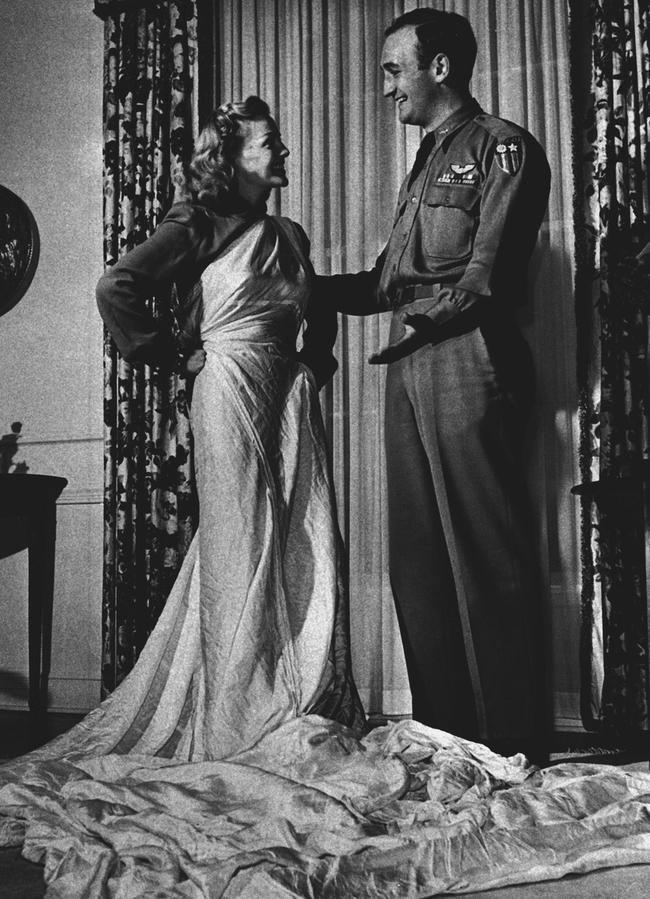 Elyse Knox, with husband-to-be footballer Tom Harmon, draped in the parachute that saved his life and became her wedding dress in 1944. Picture: AP