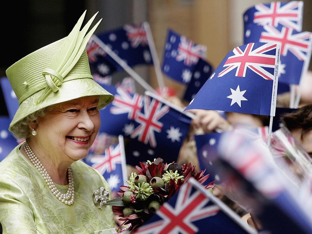 <b>2006 – Sydney</b> Wellwishers wave Australian flags as the Queen greets the crowd after attending a Commonwealth Day service in Sydney as part of her 2006 tour with Prince Philip. Picture: Getty