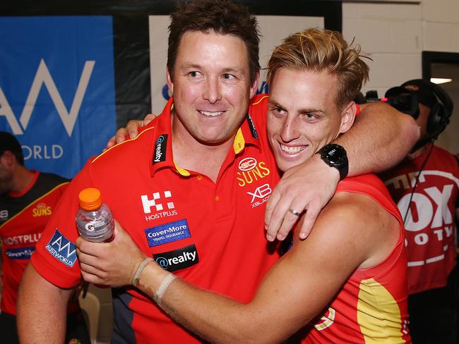 Darcy Macpherson of the Suns celebrates the win with Suns head coach Stuart Dew during the round three AFL match between the Western Bulldogs and the Gold Coast Suns at Marvel Stadium on April 07, 2019 in Melbourne, Australia. (Photo by Michael Dodge/Getty Images)