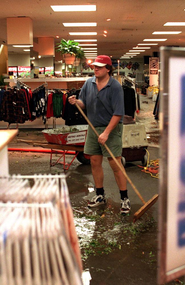 Workers begin the clean-up operation on the ground floor of Myer at Chermside shopping centre after storm damage in April 1997.