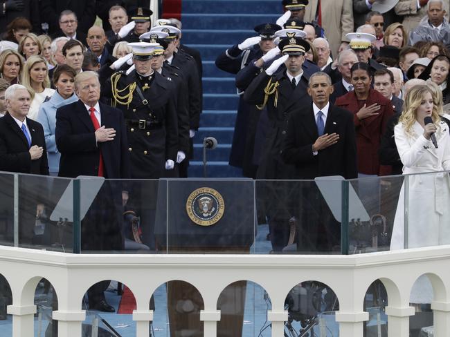 President Donald Trump and Vice President Mike Pence listen to the National Anthem sung by Jackie Evancho with former President Barack Obama and his wife Michelle during the 58th Presidential Inauguration at the U.S. Capitol in Washington on January 20, 2017. Picture: AP