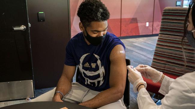 Student Julius Irvin receives a Covid-19 vaccine at the University of Washington. Picture: AFP.