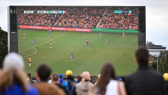 People gather outside of the stadium to watch the Matilda's World Cup match during the 2023 AFL Round 22 match between the West Coast Eagles and the Fremantle Dockers at Optus Stadium on August 12, 2023 in Perth, Australia. (Photo by Daniel Carson/AFL Photos via Getty Images)