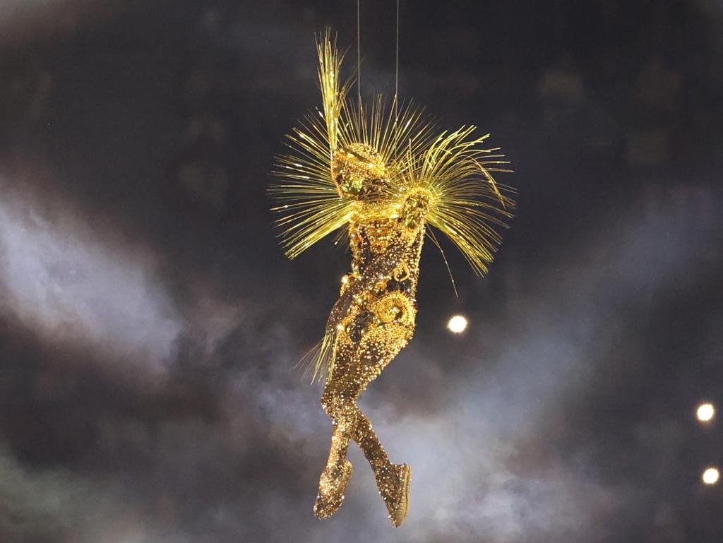 The Golden Voyager descends as part of the spectacular light show, symbolic of the victory of light over darkness in a time of global turmoil. Picture: Luke Hales/Getty Images