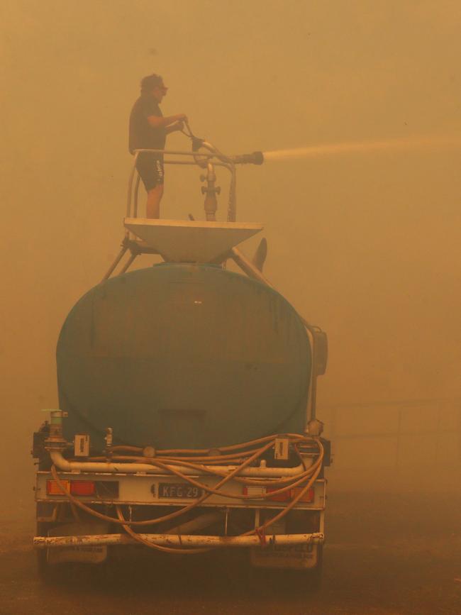 Mr Rhind works through the smoky haze. Picture: Nathan Edwards