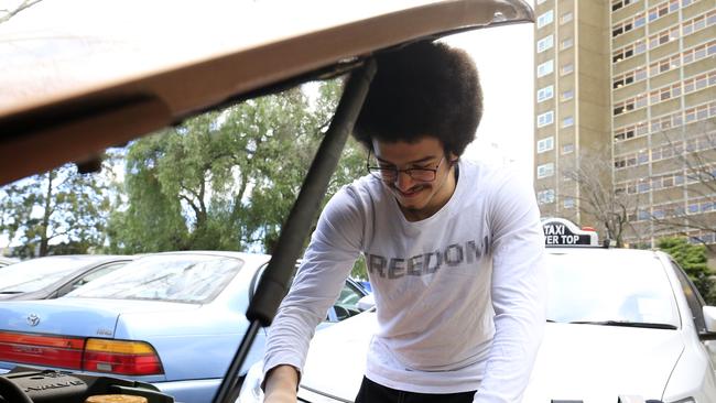 Ali Abdalla wears a t-shirt emblazoned with the word ‘freedom’ as he leaves the North Melbourne tower block for the first time in 14 days. Picture: Darrian Traynor/Getty Image.