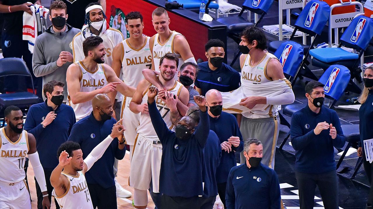 Team owner Mark Cuban of the Dallas Mavericks hugs Luka Doncic. Justin Ford/Getty Images/AFP