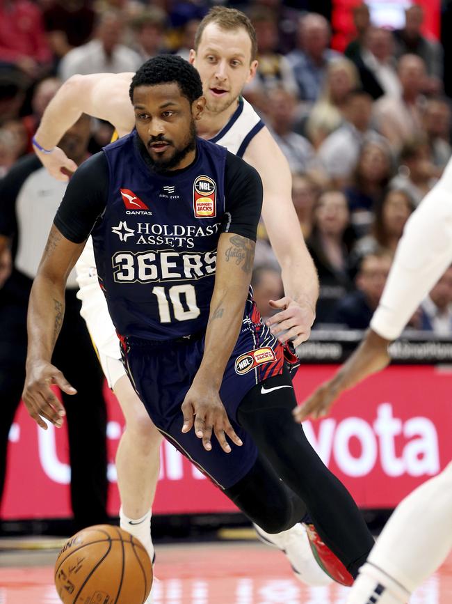 Adelaide export and Utah Jazz forward Joe Ingles, rear, tries to knock the ball away from Adelaide 36ers guard Ramone Moore. Picture: Scott G Winterton/The Deseret News via AP)