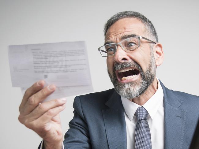 Furious business man shocked and angry with expensive bills he receives at his office, electricity money generic