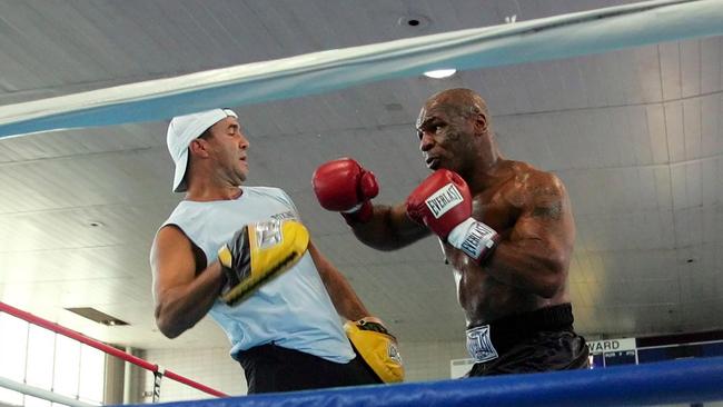 Fenech training Tyson in 2005. Picture: AP Photo/Pablo Martinez Monsivais