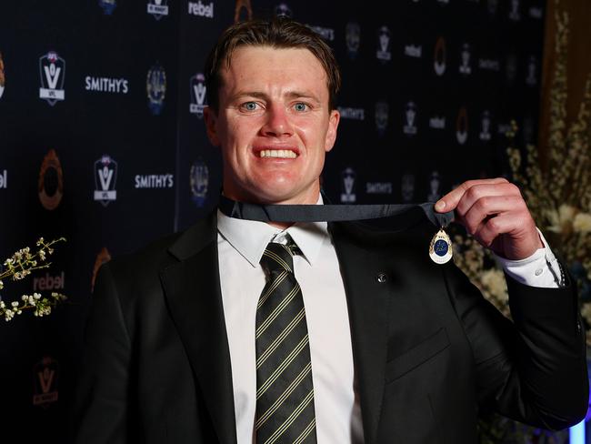 Dom Brew shows off his medal after streaking away with the JJ Liston Trophy. Picture: Morgan Hancock/AFL Photos/via Getty Images