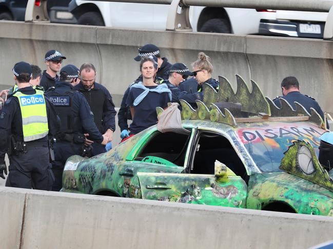 A woman caused traffic chaos on Saturday when she chained herself to a vehicle. Picture: David Crosling