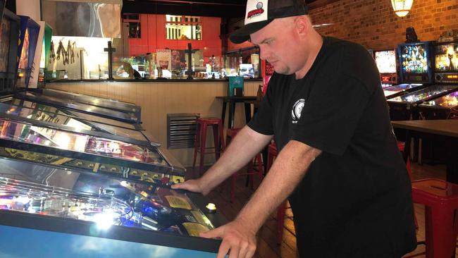 Jason Lambert of Aspley playing the pinball machines at Pincadia, Woolloongabba.