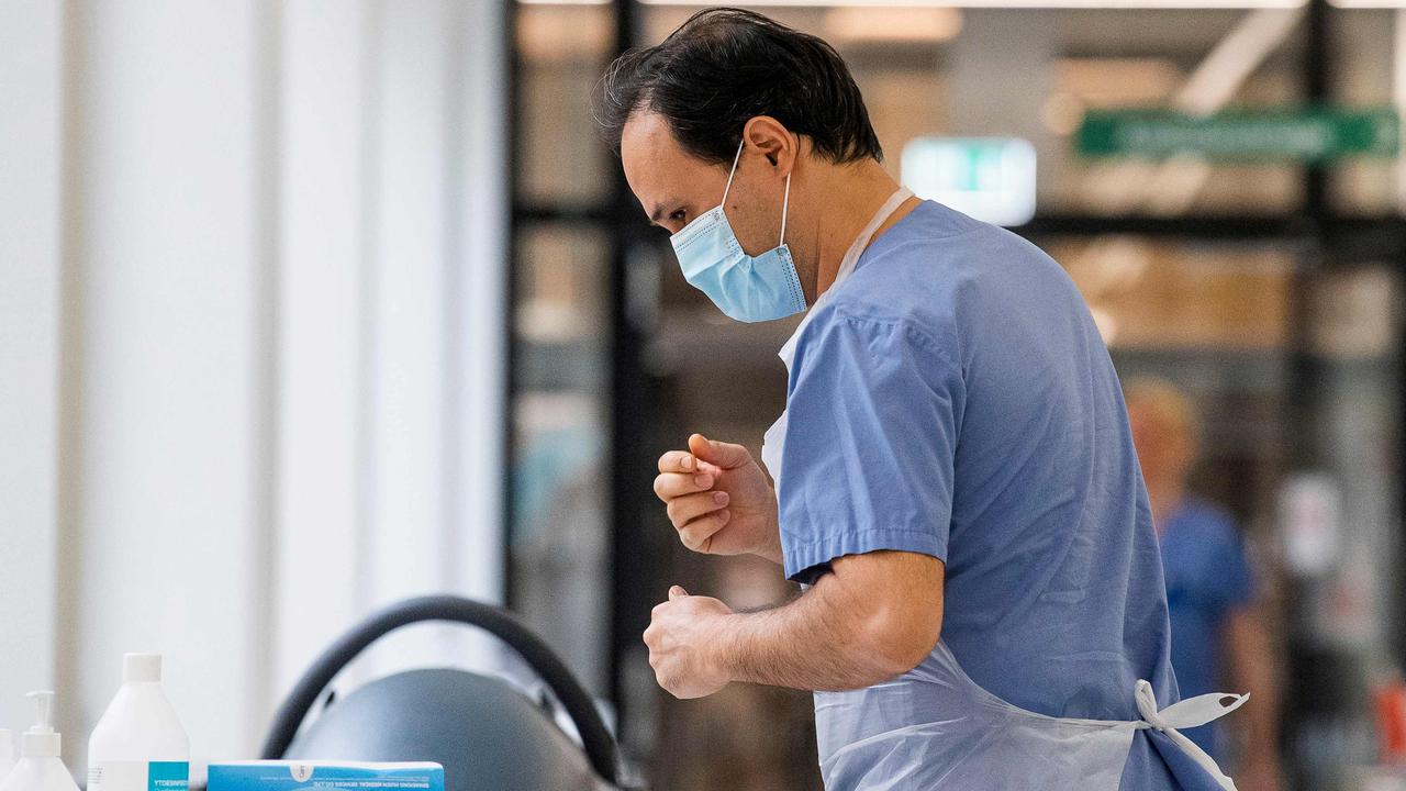 A healthcare worker puts on protective gear as he prepares to receive a patient at the Intensive Care Unit at Danderyd Hospital near Stockholm. Picture: Jonathan Nackstrand/AFP