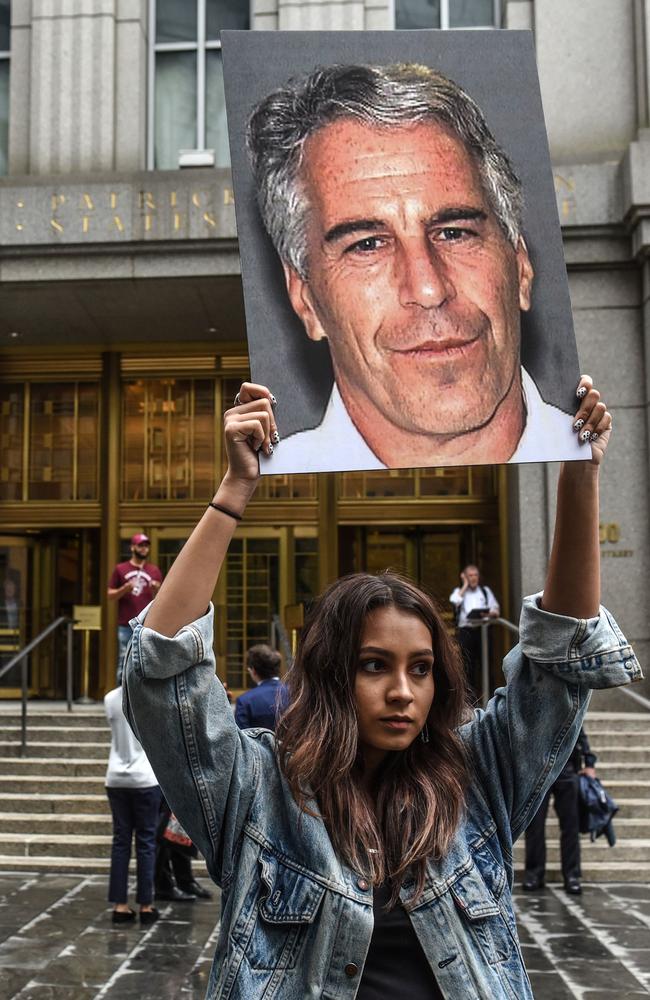 In this file photo taken on July 8, 2019, a protest group called ‘Hot Mess’ hold up photos of Jeffrey Epstein in front of the Federal courthouse in New York City. Picture: Stephanie Keith / Getty Images North America / AFP