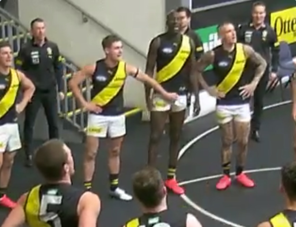 Richmond player Mabior Chol (centre) appears to be groped by a teammate.