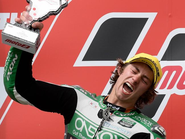 Runner-up Kalex's Australian Remy Gardner (L) celebrates with his trophy as winner Kalex's Italian rider Lorenzo Baldassarri applauds on the podium of the Argentina Grand Prix Moto2 race at the Termas de Rio Hondo circuit in Santiago del Estero, Argentina, on March 31, 2019. (Photo by Juan MABROMATA / AFP)