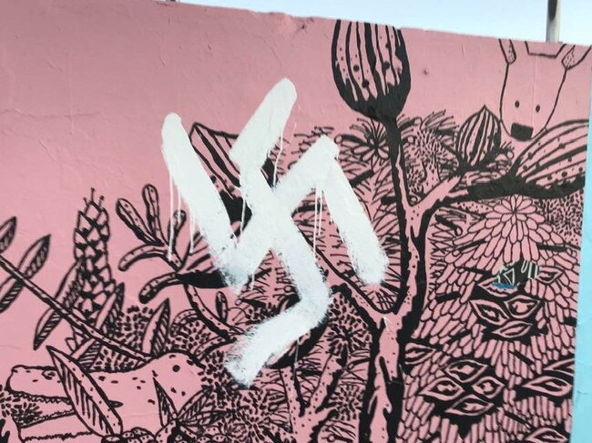 Several swastikas and racial epithets were graffitied over public artwork on the Bondi Beach boardwalk for the second time. Picture: Facebook