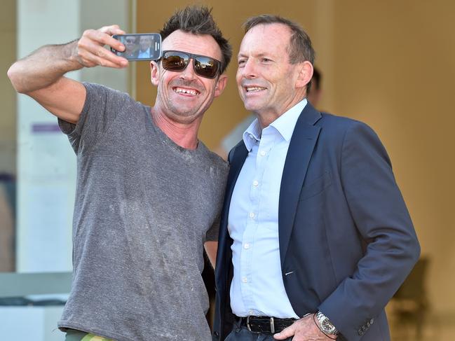 Tony Abbott poses for a selfie with a voter outside a prepoll voting centre at Brookvale. Picture: Troy Snook