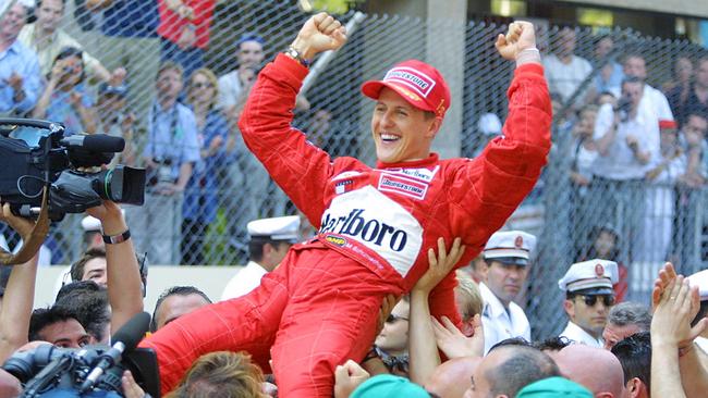 German Ferrari driver Michael Schumacher is lifted in triumph after winning the 59th Monaco Formula One Grand Prix. (Photo by Patrick HERTZOG / AFP)