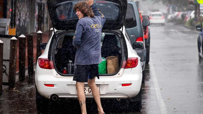 A resident packs a car of stock from a shop in the town of Lismore on March 5, 2025. A rare tropical cyclone veered towards Australia's densely populated eastern coast on March 5, forcing scores of schools to close as worried residents stripped supermarket shelves bare. (Photo by DAVID GRAY / AFP)