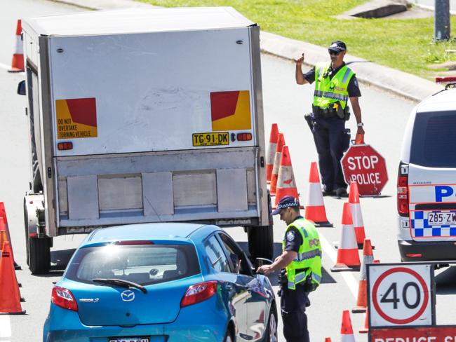 Police at the Queensland border on the Gold Coast Highway. Picture: NIGEL HALLETT