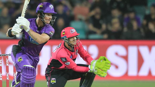 D'Arcy Short of the Hurricanes (left) plays front of Sixers keeper Josh Philippe during the Big Bash League (BBL) match between the Hobart Hurricanes and the Sydney Sixers at Blundstone Arena in Hobart, Friday, January 4, 2019. (AAP Image/Rob Blakers)